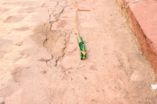 Huge firecracker on the ground before it explodes, during a celebration.