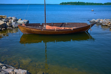 wooden boat during sunny day with reflections