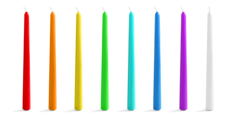 Set with different decorative wax candles on white background