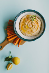 homemade hummus on blue background