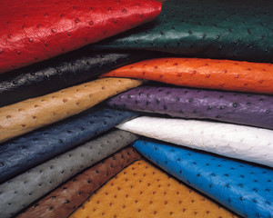 A pile of colourful folded ostrich leather