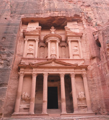 Women hiking down a rocky ravine in the desert of Petra along the Jordan Trail. 