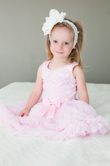 Close up portrait of Cute Blonde Toddler, 3 Years Old Girl, with Big Blue Eyes, in Pink fluffy Dress, Happy Child, The Most Beautiful Girl in the world © Olga