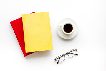Books with empty cover near glasses, coffee on white desk background top view