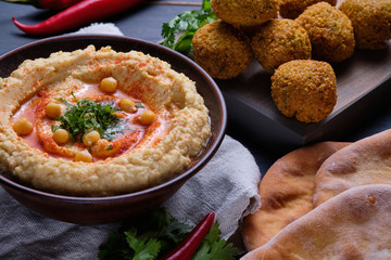 Classic hummus, falafel and homemade baked pita on the dining table. National, vegetarian food.