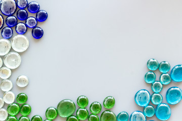 Shiny glass stones for decoration, creativity and craft on gray background top view copyspace