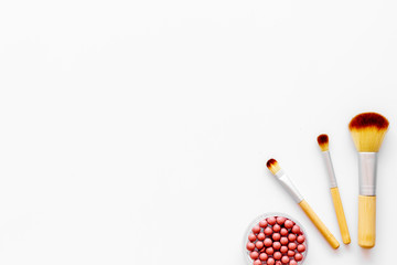 Brushes for make up, blusher on white visagiste work desk background top view copyspace