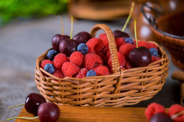 Raspberries ,cherries and blueberries in the basket