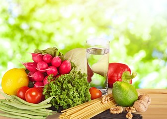 Fresh tasty vegetables with water on background