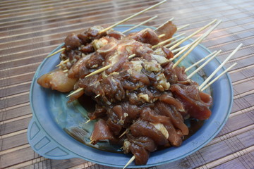 Raw pork skewer in bamboo stick