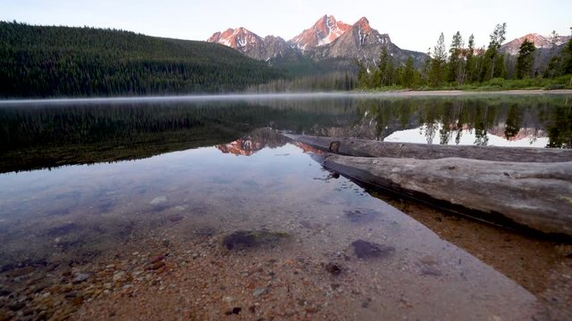 Beautiful sunrise at Stanley Lake in the Sawtooth Mountains of Idaho. Reflection in water as it ripples