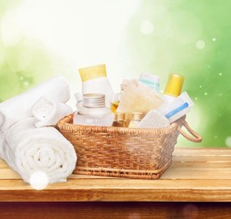 Bath towel and basket with accessories for spa on blur background