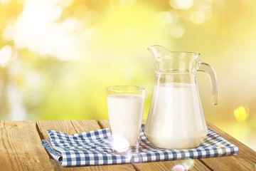 Glass of milk and bottle on  background