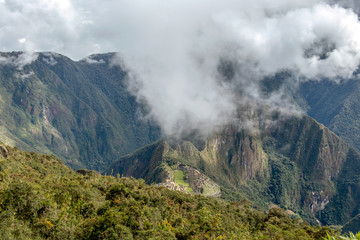 Huayna Picchu, or Wayna Pikchu, mountain in clouds rises over Machu Picchu Inca citadel, lost city of the Incas