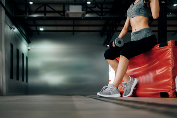 sport woman at fitness gym club doing exercise for arms with dumbbells and showing muscle bodybuilding, fitness concept, sport concept