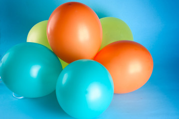 Many colorful balloons on blue background. Happy birthday, wedding, honeymoon party concept, joy and lifestyle.