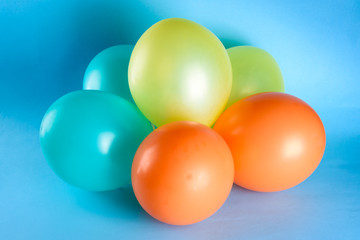 Many colorful balloons on blue background. Happy birthday, wedding, honeymoon party concept, joy and lifestyle.