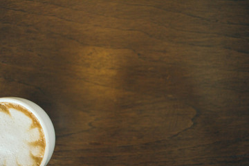 Coffee cup and coffee beans on wooden table  in cafe