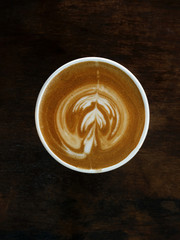 Coffee cup cappuccino latte foam top view on old wooden