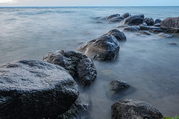 sunset at Willow Beach Georgina Ontario Canada with rocks formation, sky, clouds, light, and lake view