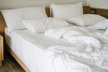 Fototapeta na wymiar messy white blanket on bed in bedroom in morning