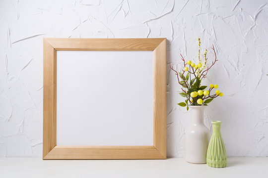 Wooden square frame mockup with yellow decoration