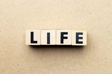 Alphabet letter block in word life on wood background