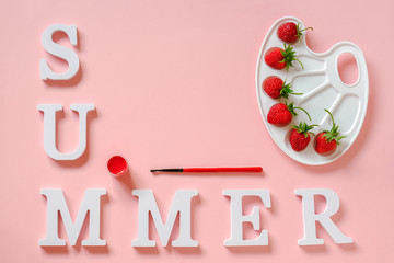 Text Summer, red ripe strawberries on an artistic palette, brush and gouache on pink background...