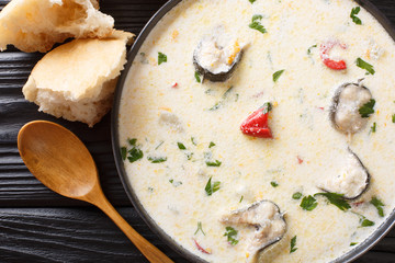 Cream eel soup with vegetables close-up in a bowl. horizontal top view