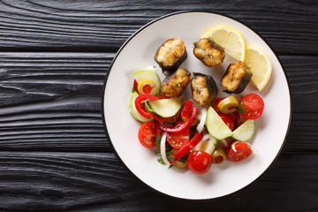 Gourmet food fried eel with fresh vegetable salad close-up on a plate. Horizontal top view