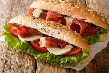 Hearty Italian sandwiches with prosciutto ham, mozzarella cheese, tomatoes and leaf lettuce...
