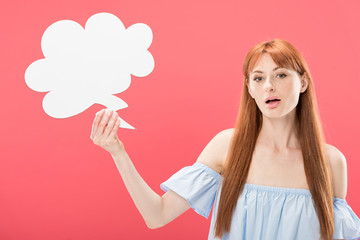 surprised redhead young woman holding empty thought bubble isolated on pink