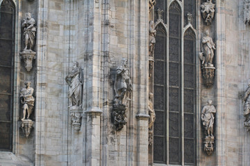 The marvellous statue are decorating on the white wall surrounding Duomo milano, The mistery art on external building of Famous white Architectural cathedral church at Milan, Largest church in Italy