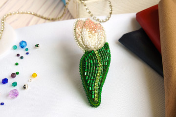 Brooch Tulip flower beaded on the table on white background