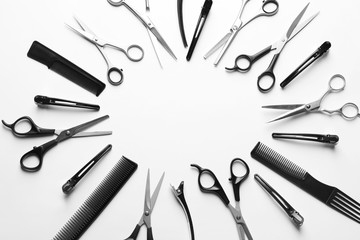 Frame made of scissors and other hairdresser's accessories on white background, top view. Space for text