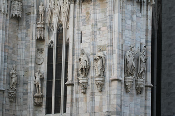 The marvellous statue are decorating on the white wall surrounding Duomo milano, The mistery art on...