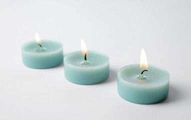 Fototapeta na wymiar Light blue wax decorative candles isolated on white