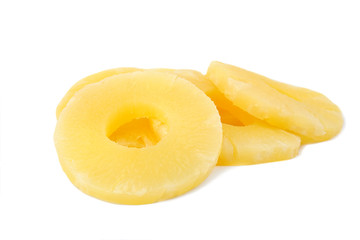 Slices of delicious sweet canned pineapple on white background