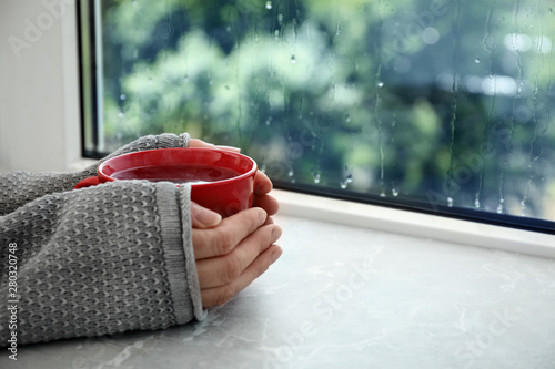Woman With Cup Of Hot Tea Near Window On Rainy Day Closeup Space For Text Wall Mural New Africa Woman With Cup Of Hot Tea Near Window On Rainy Day Closeup Space For Text Wall Mural New Africa