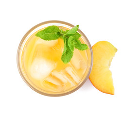 Delicious refreshing peach cocktail in glass and fresh fruit on white background, top view