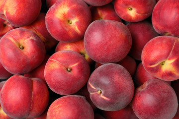 Delicious ripe peaches as background, top view
