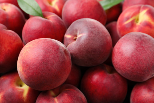 Delicious ripe sweet peaches as background, closeup