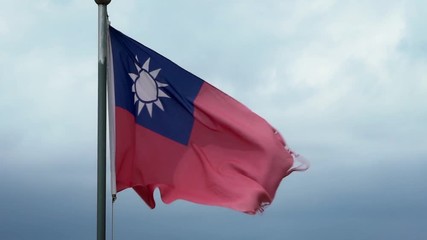 Slow motion taiwanese flag waving in the wind on flagpole at an Taipei city. Slow-motion of Taiwan banner flutters at day in front of blue sky. Close up of a real fabric texture ensign fluttering-Dan