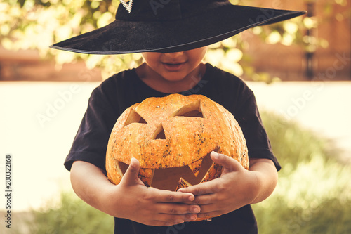 Boy holding halloween pumpkin