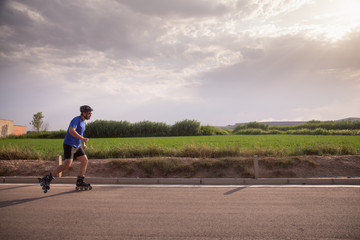 man with inline skates skating on the street