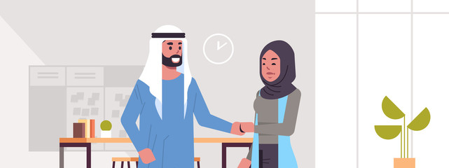 arabic businesspeople man woman handshaking arab business partners couple hand shake during meeting agreement partnership concept modern co-working center office interior portrait horizontal