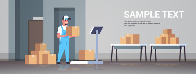 courier man in uniform putting parcel box on scales mail express delivery logistic service concept modern warehouse interior flat horizontal full length copy space