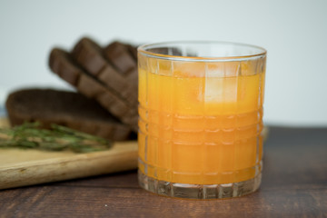Freshly squeezed orange juice with ice cubes in glass