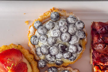 A delicious piece of fine cake with fruits on top