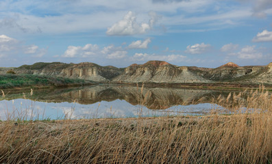 beautiful rocks with reflection in the water against the sky